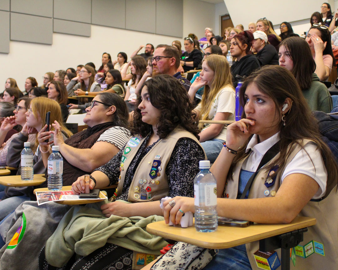 Girl Scouts and families seated in a CU Denver lecture hall
