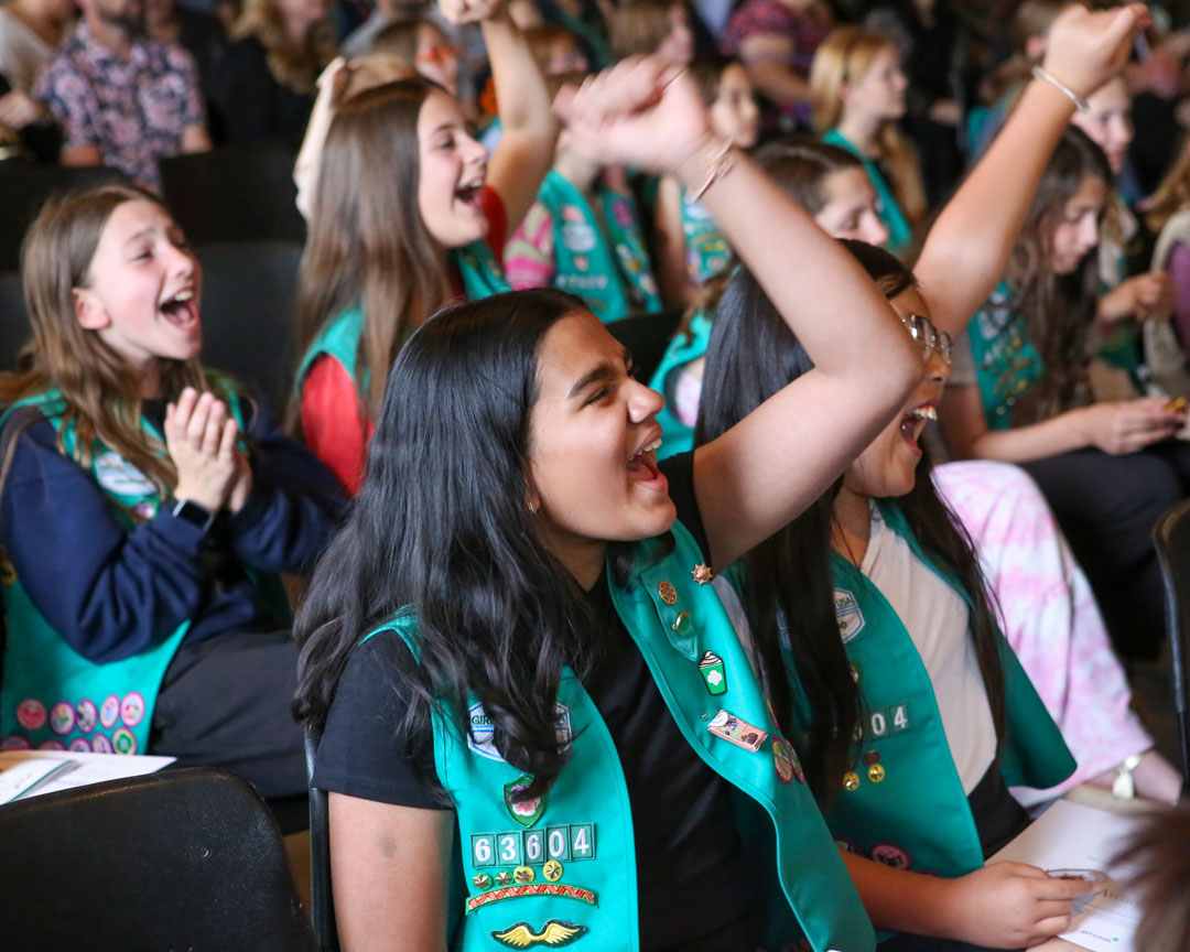 Girl Scouts cheering during a program event
