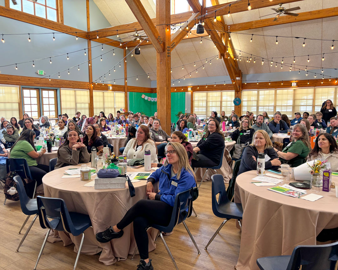 Girl Scouts of Colorado staff gathered at tables during an all-staff retreat