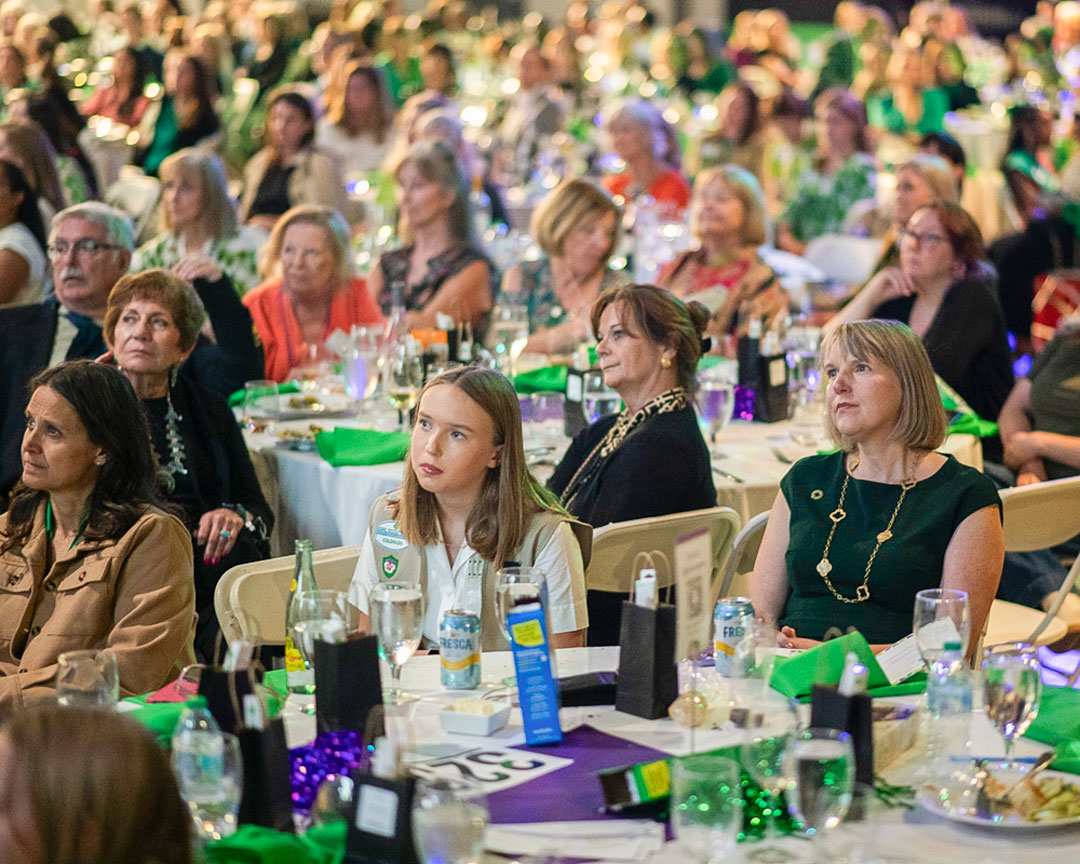 Guests seated at tables during the Women of Distinction luncheon program